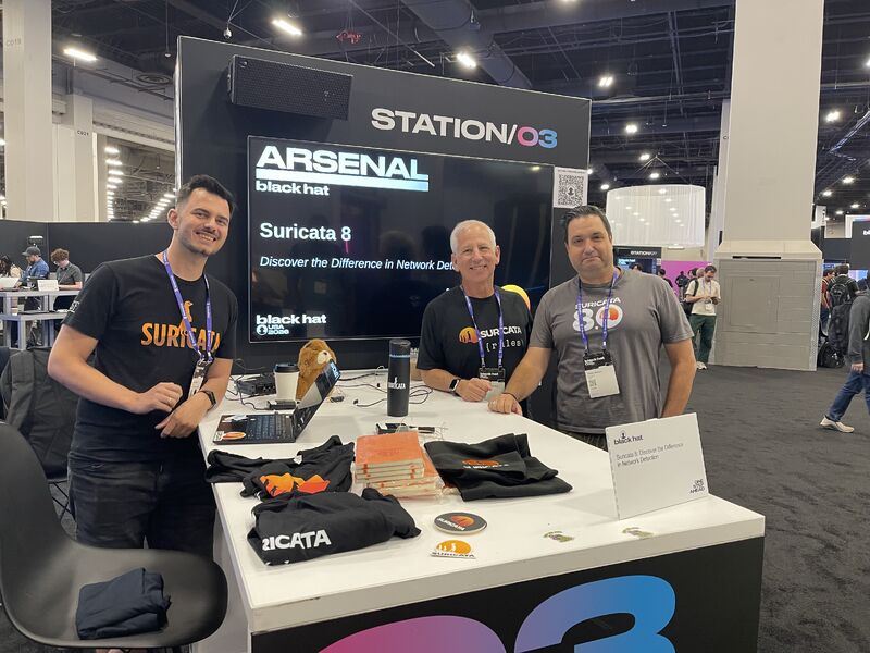 Three Suricata team members at the Suricata 8 booth at Black Hat Arsenal